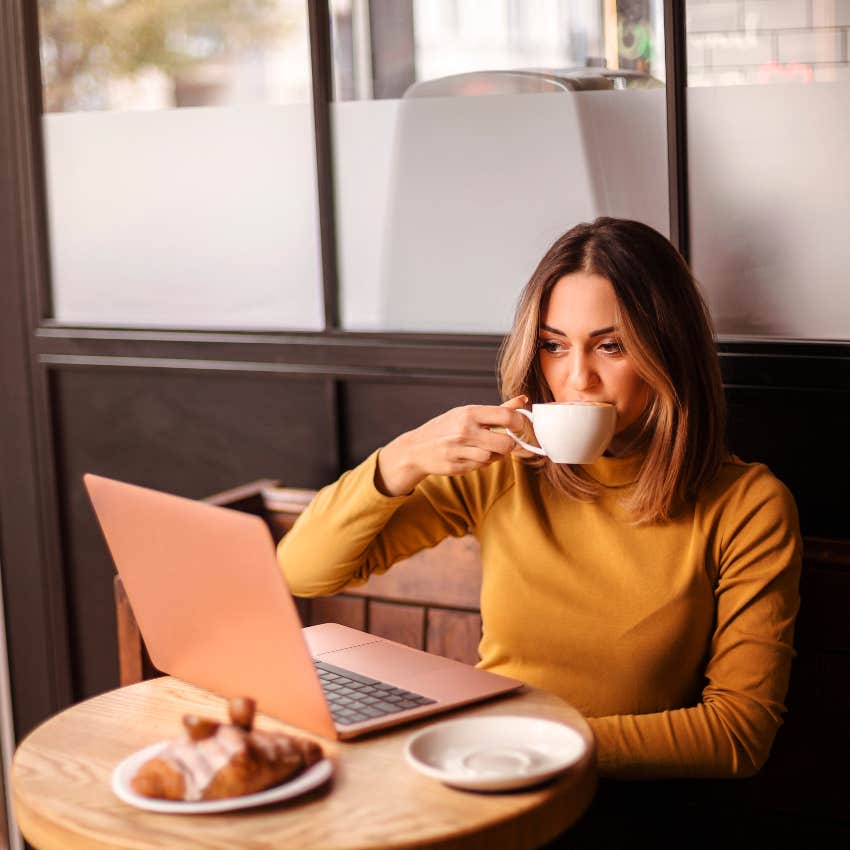 Young woman working at a table in a coffee shop