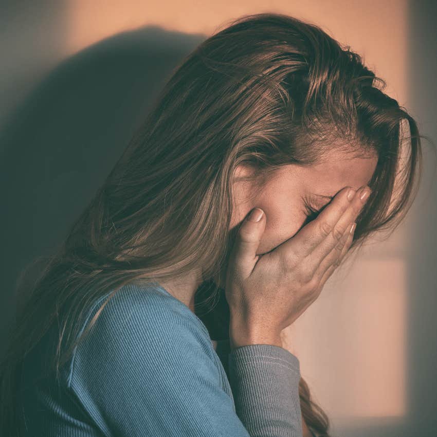 women covering face with hands