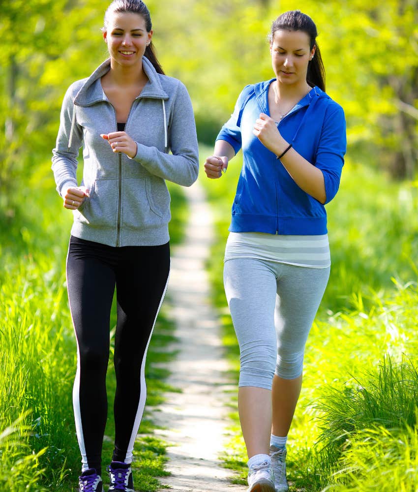 Two women walking on a park path