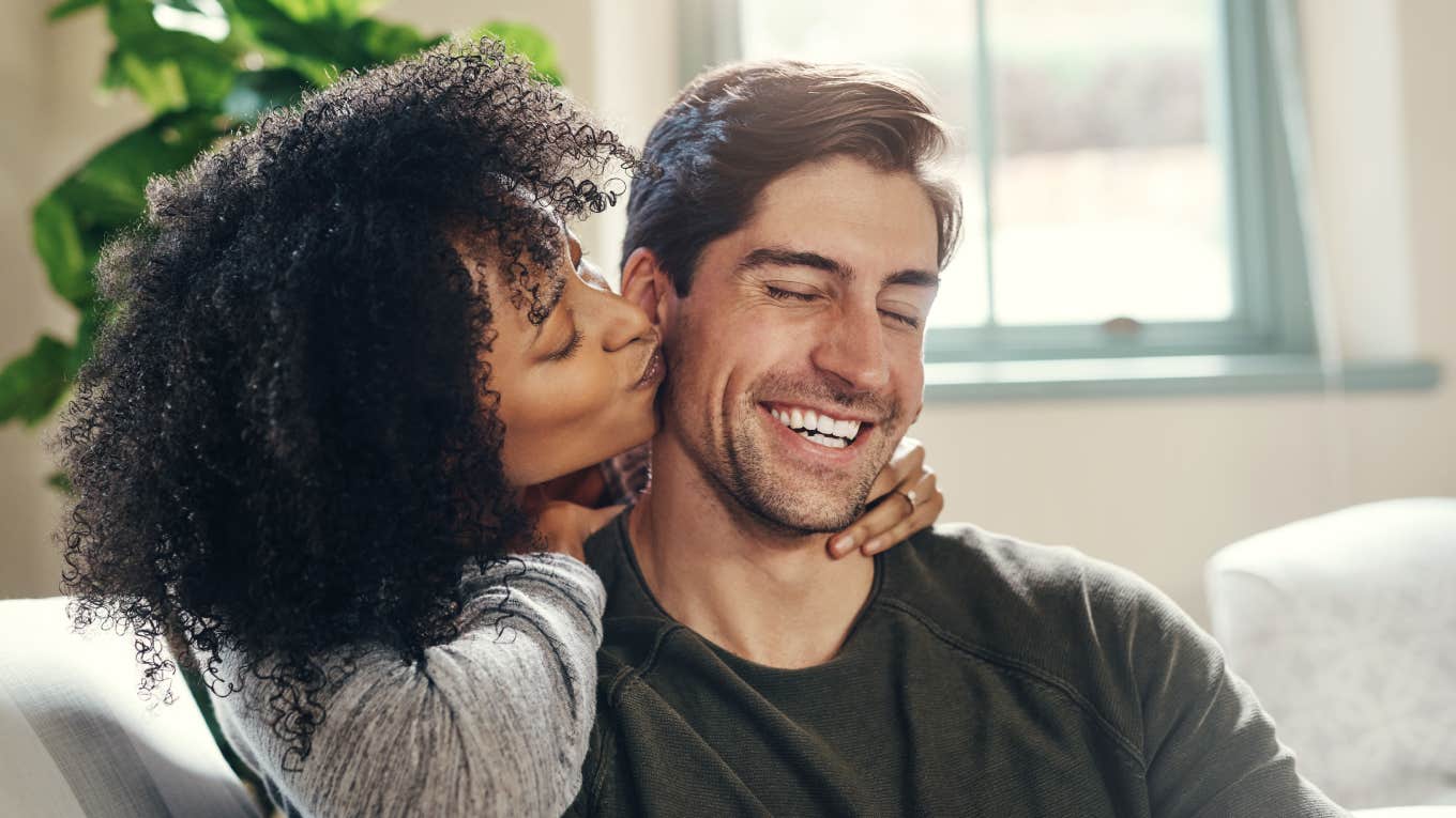 woman kissing man on cheek