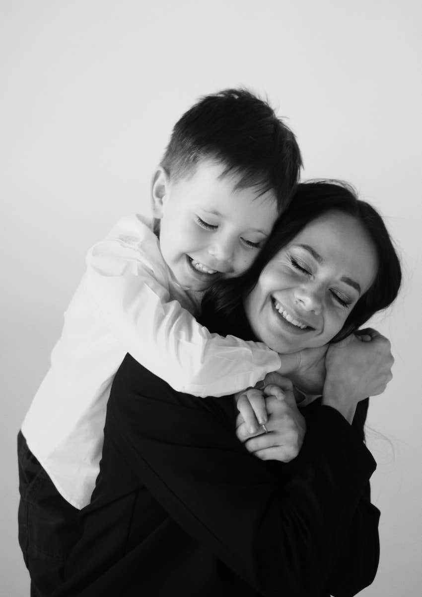 young boy hugging mom tightly