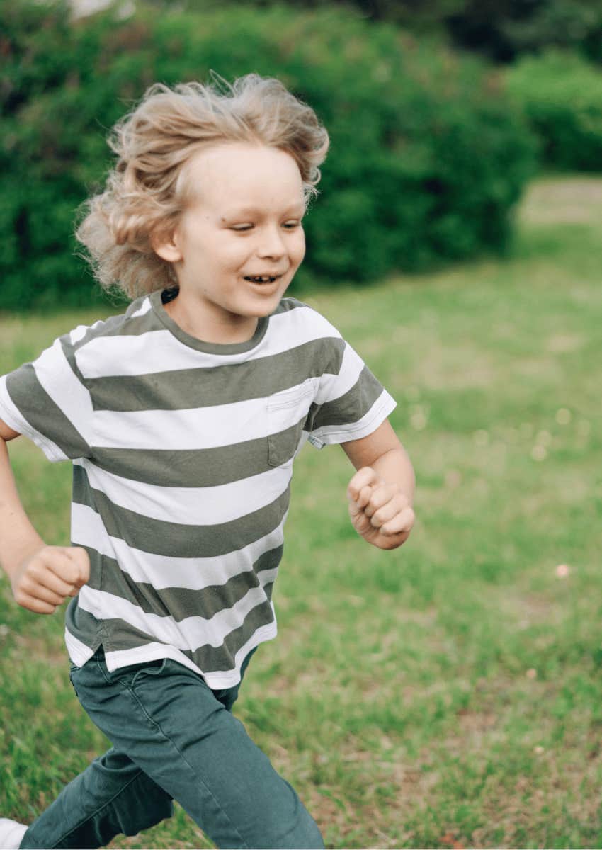 young boy running outdoors