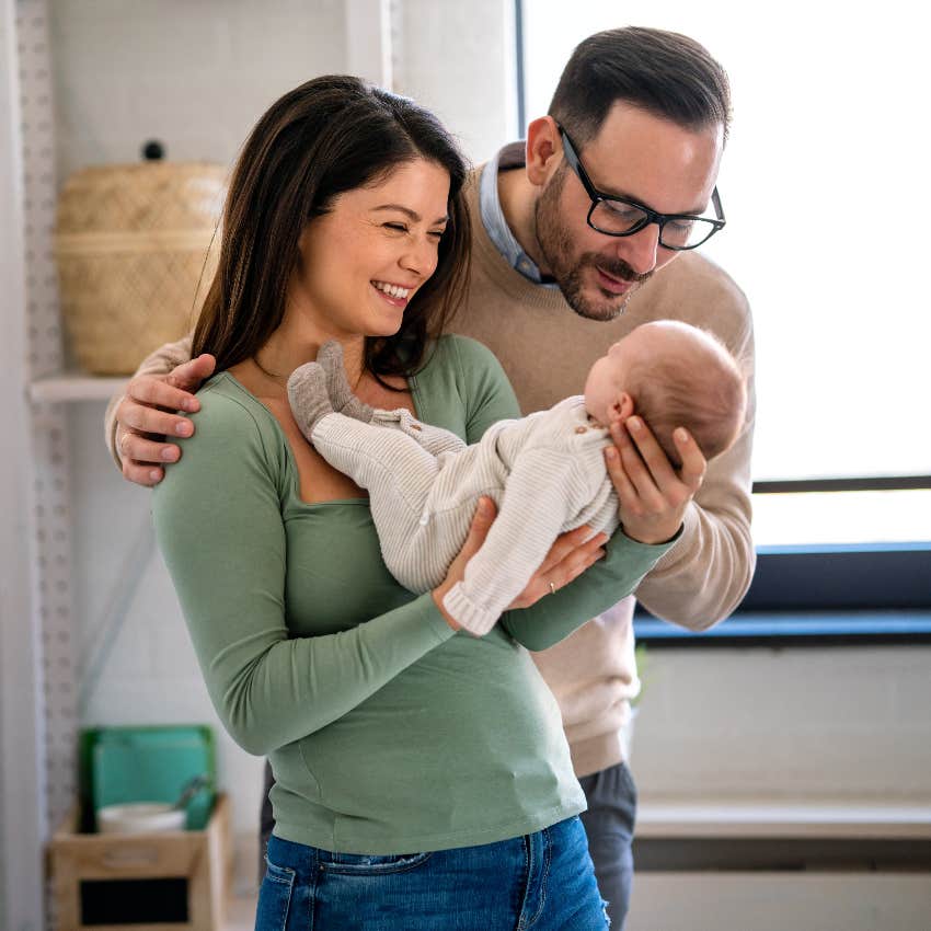 Young couple holding newborn baby