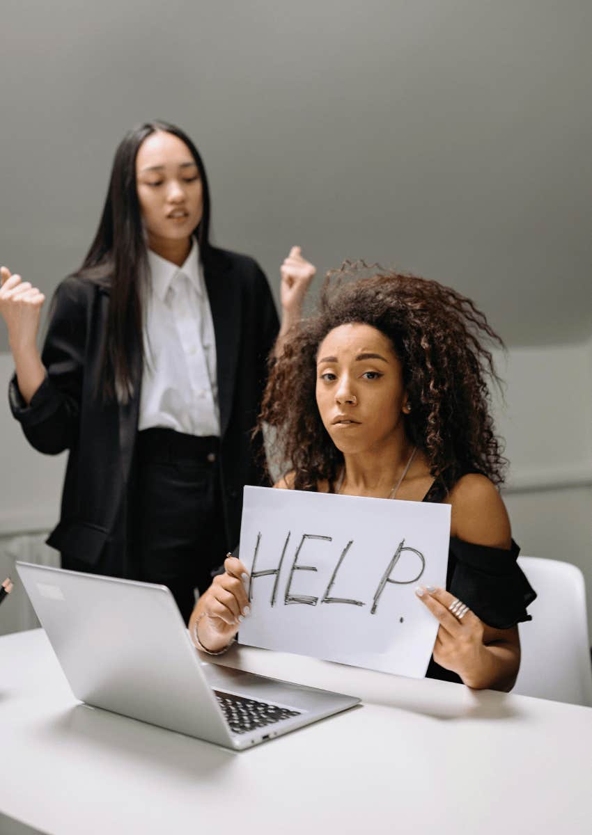 young woman holding up a help sign