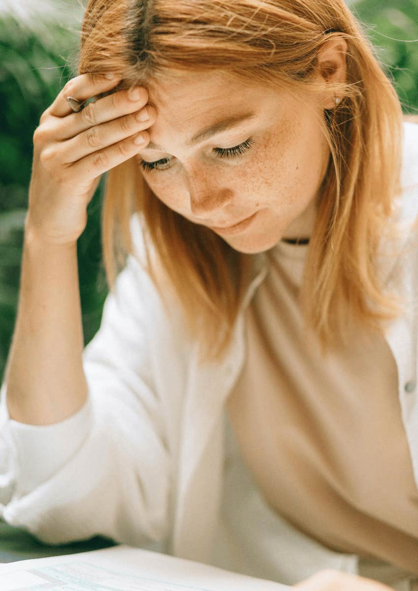 young woman staring down at forms