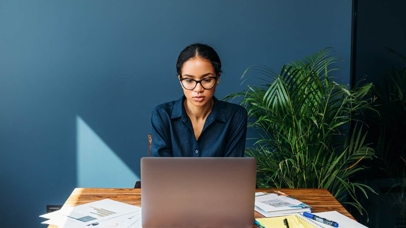 Woman diligently working at her desk in an office