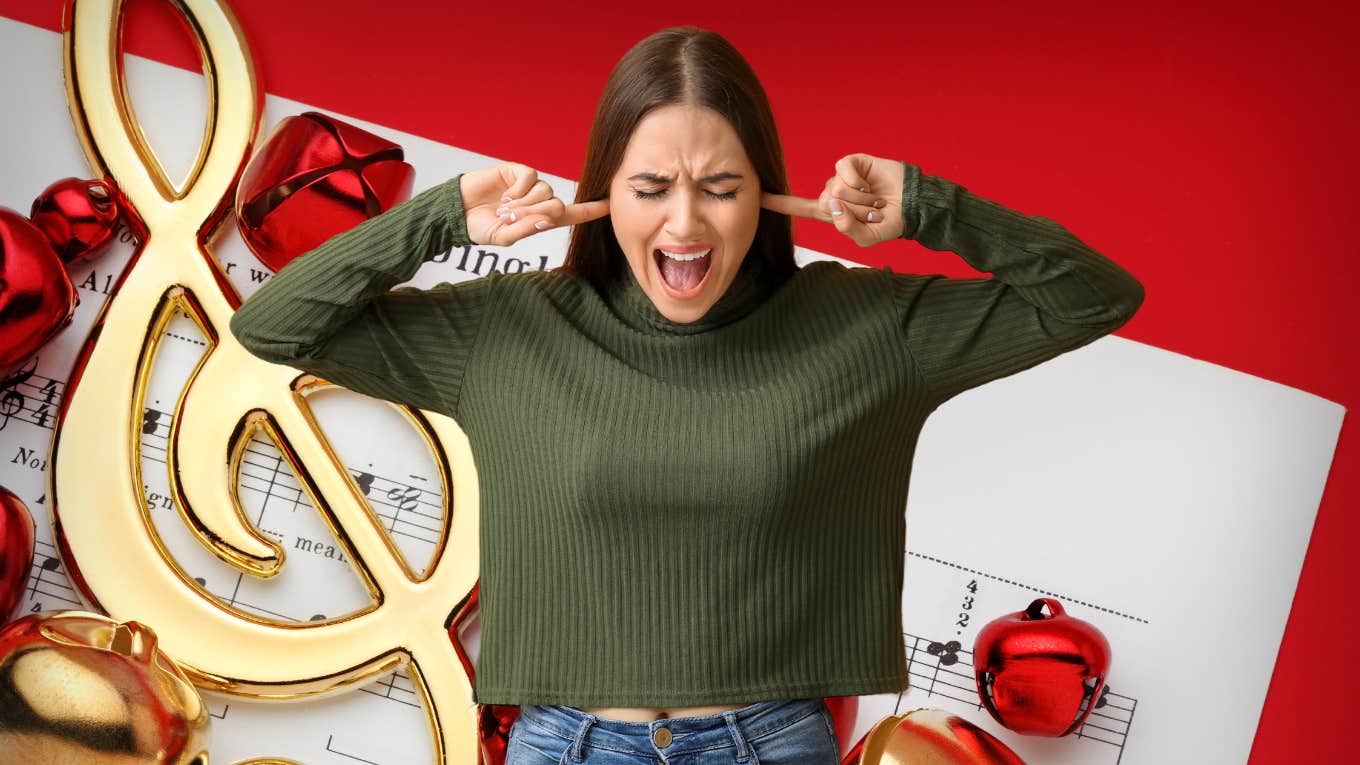 woman plugging her ears against the worst christmas songs of all time