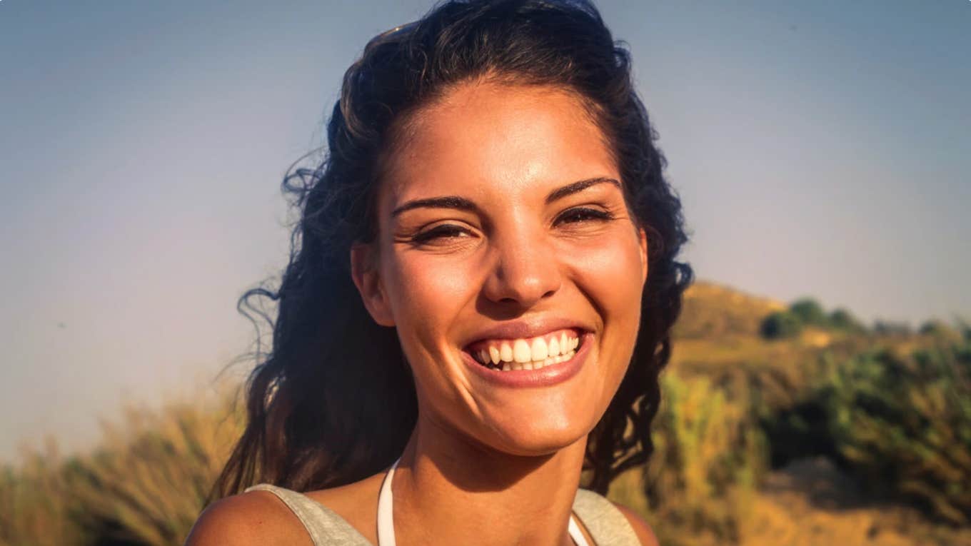 Woman outdoors happy about what influences behavior more than personality type