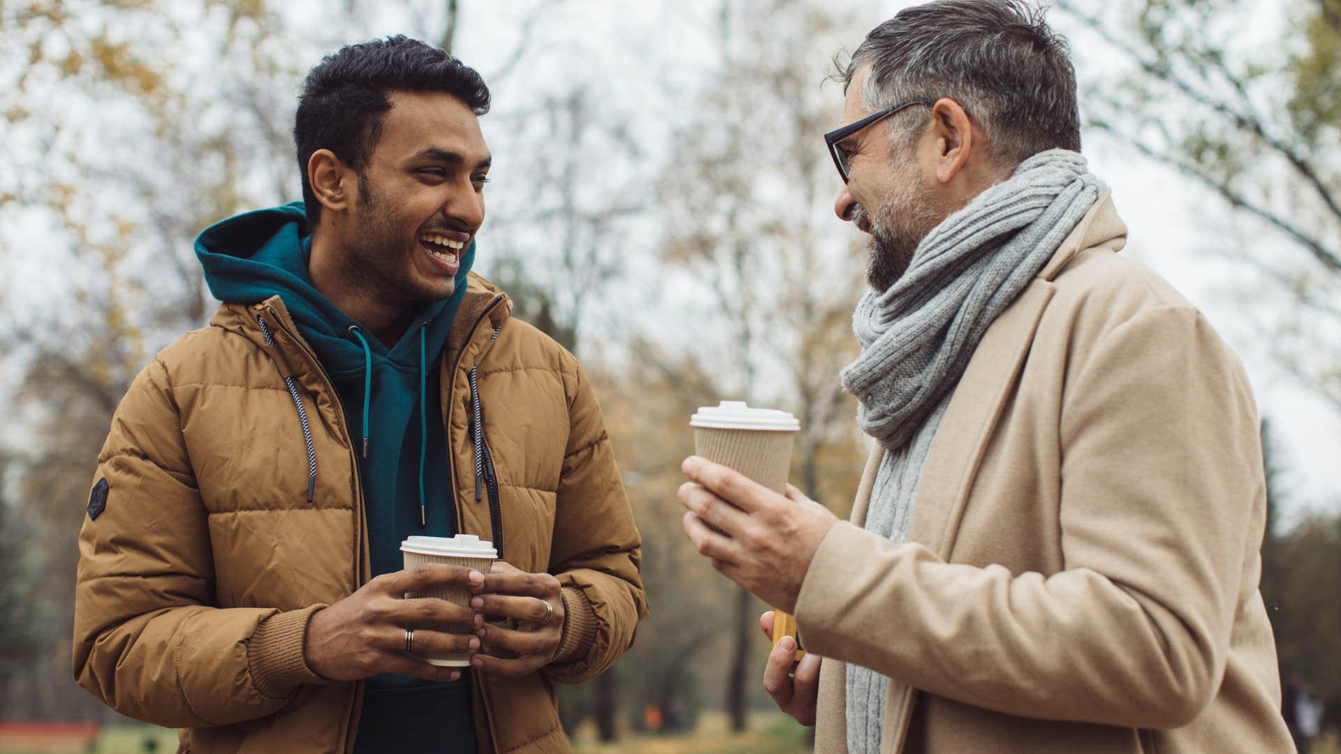 Two older men talking and drinking coffee together