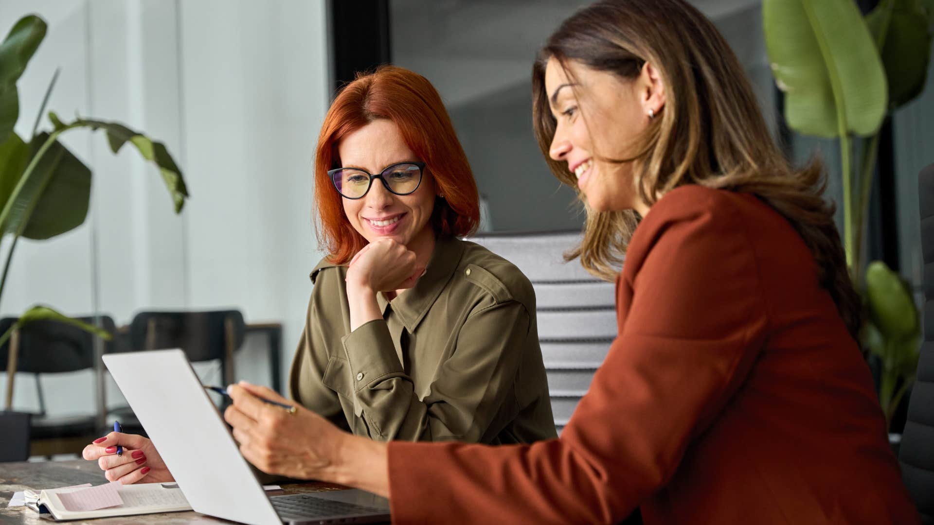 Two women talking to each other at work