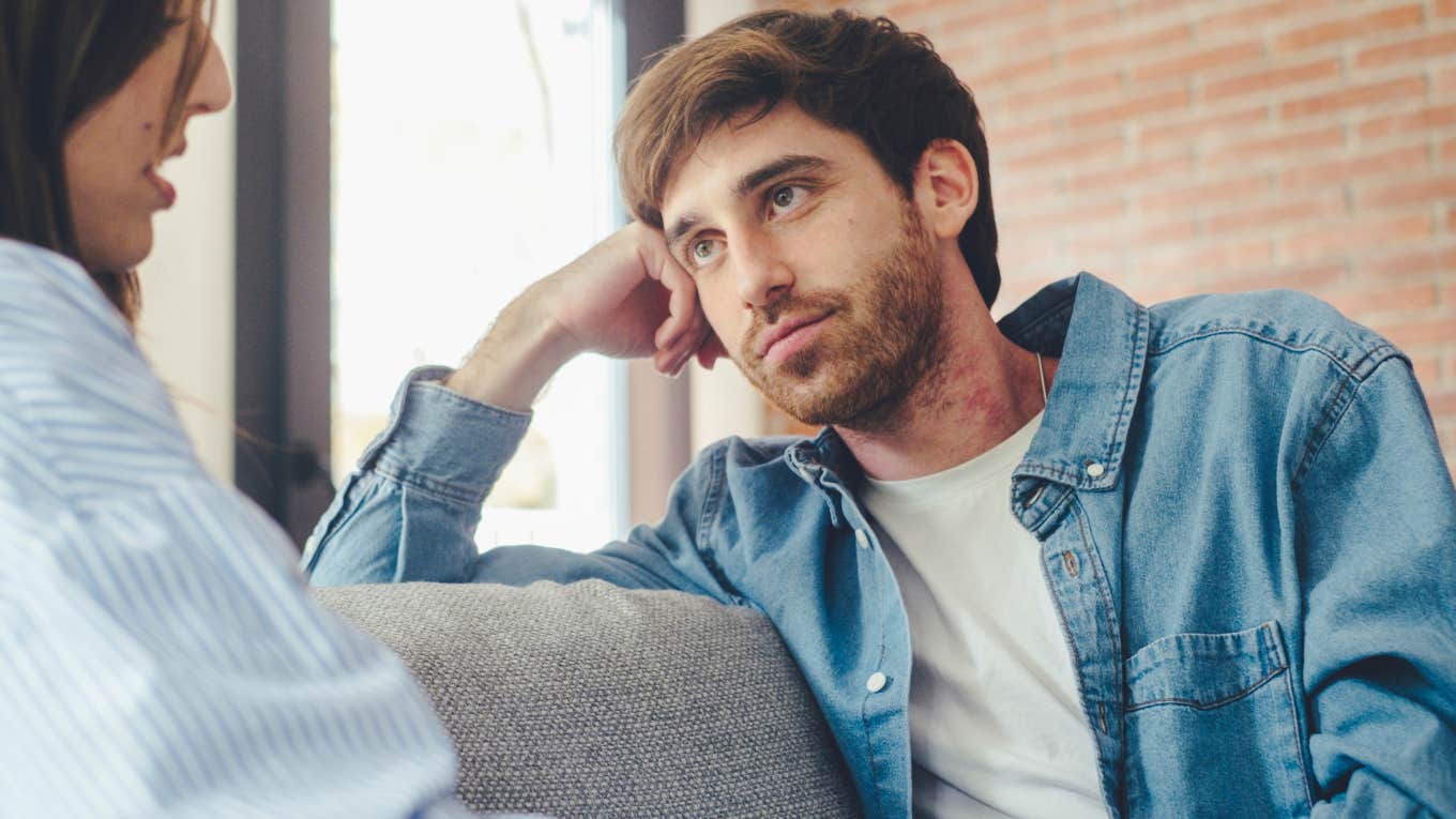 Quiet man listening to his partner talk on the couch