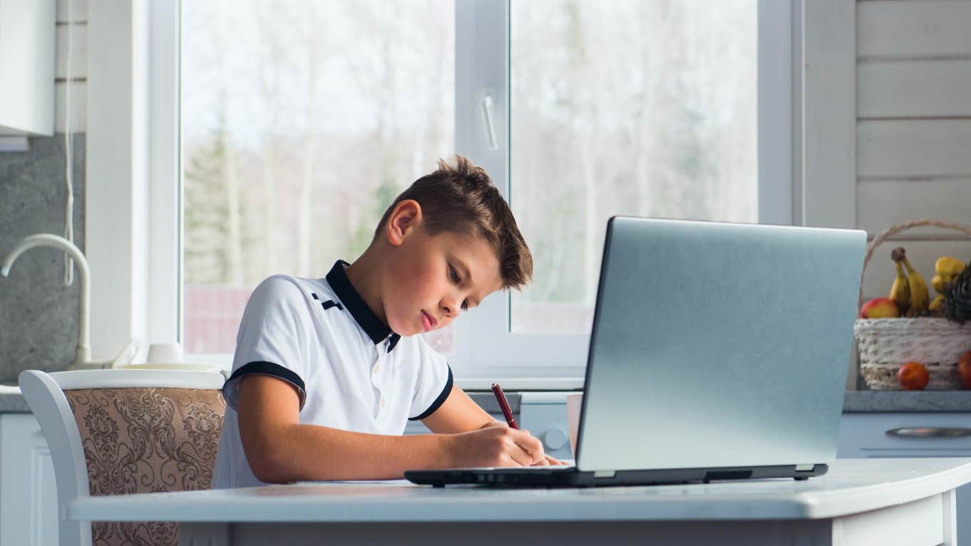 boy doing homework on computer