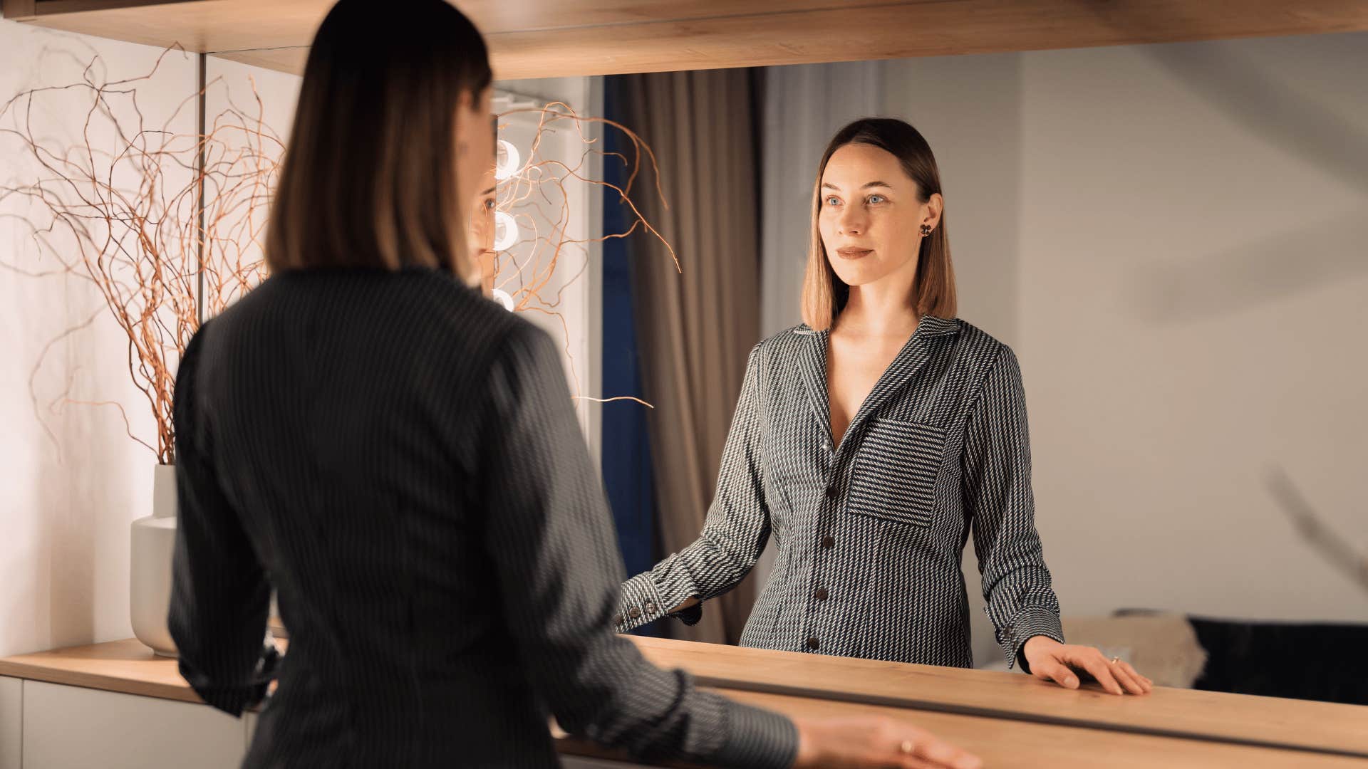 confident woman looking in the mirror