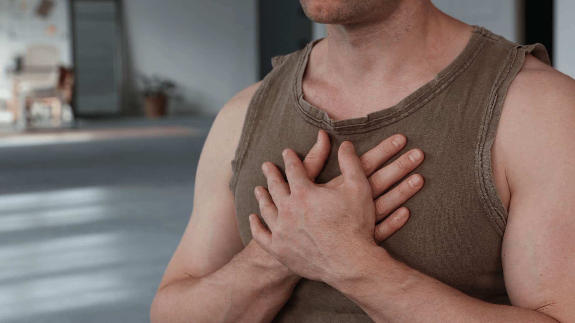 man putting his hands on his chest