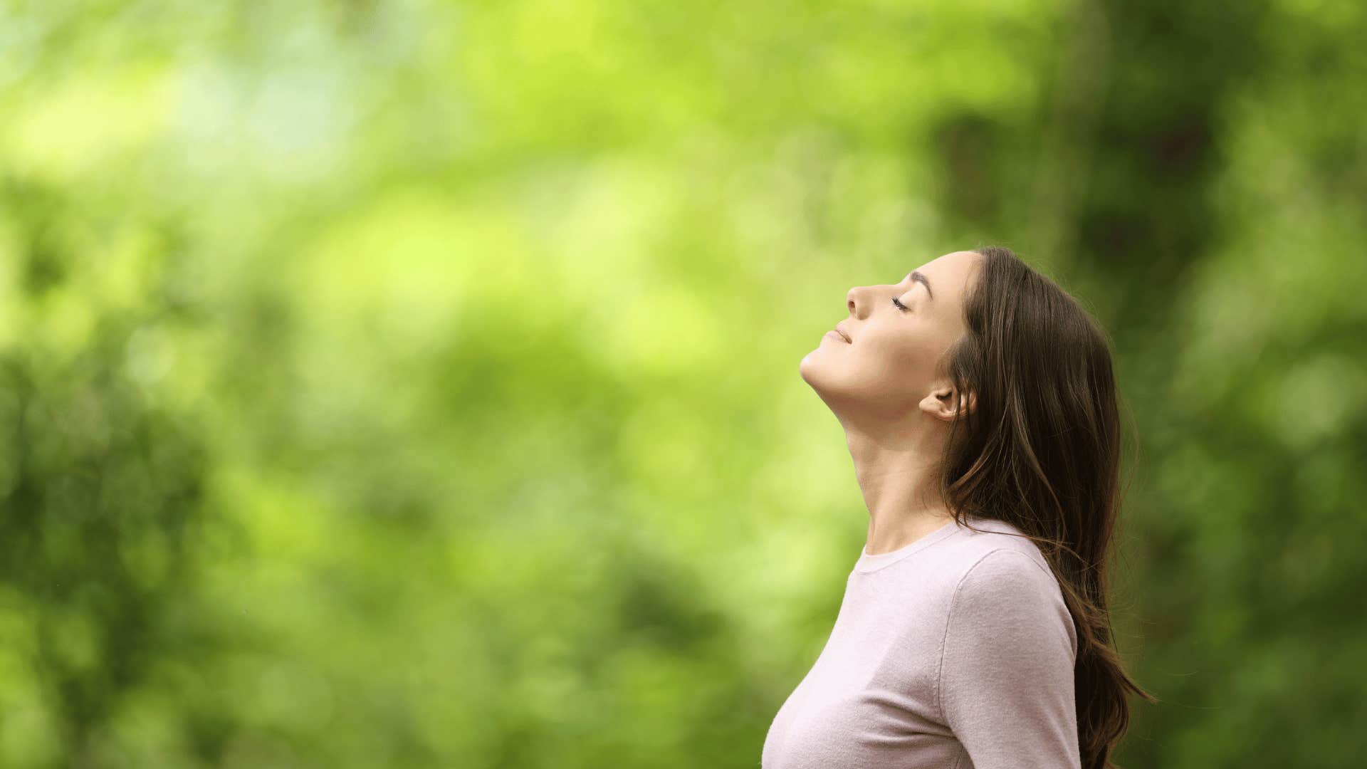 woman with her face towards the sun