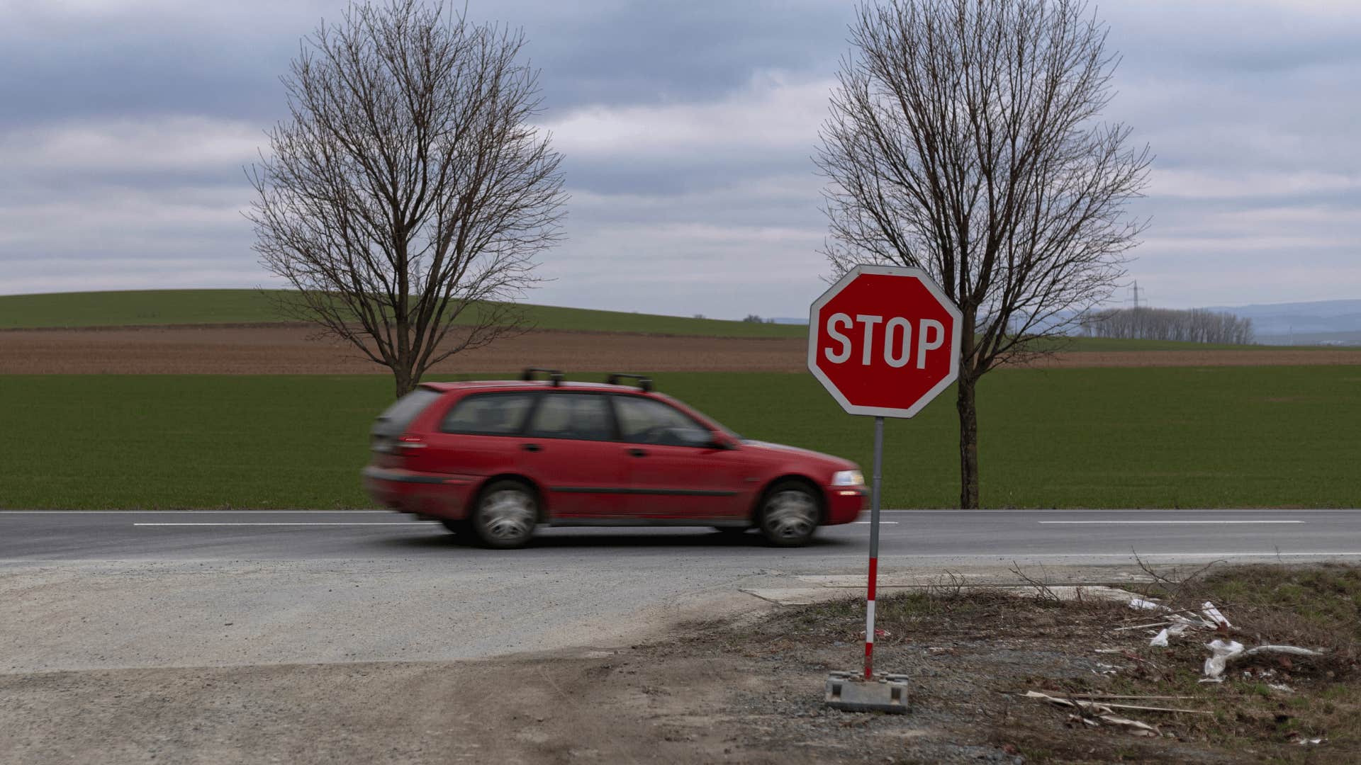 car driving past stop sign