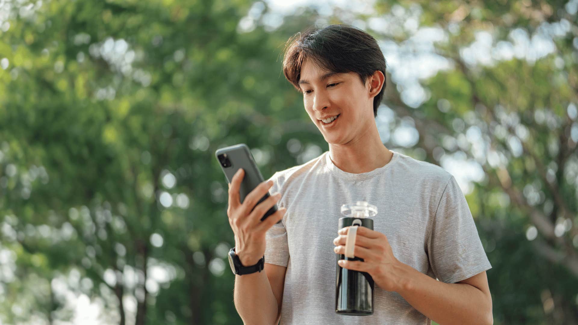 Pleased man reads text message and feels appreciated