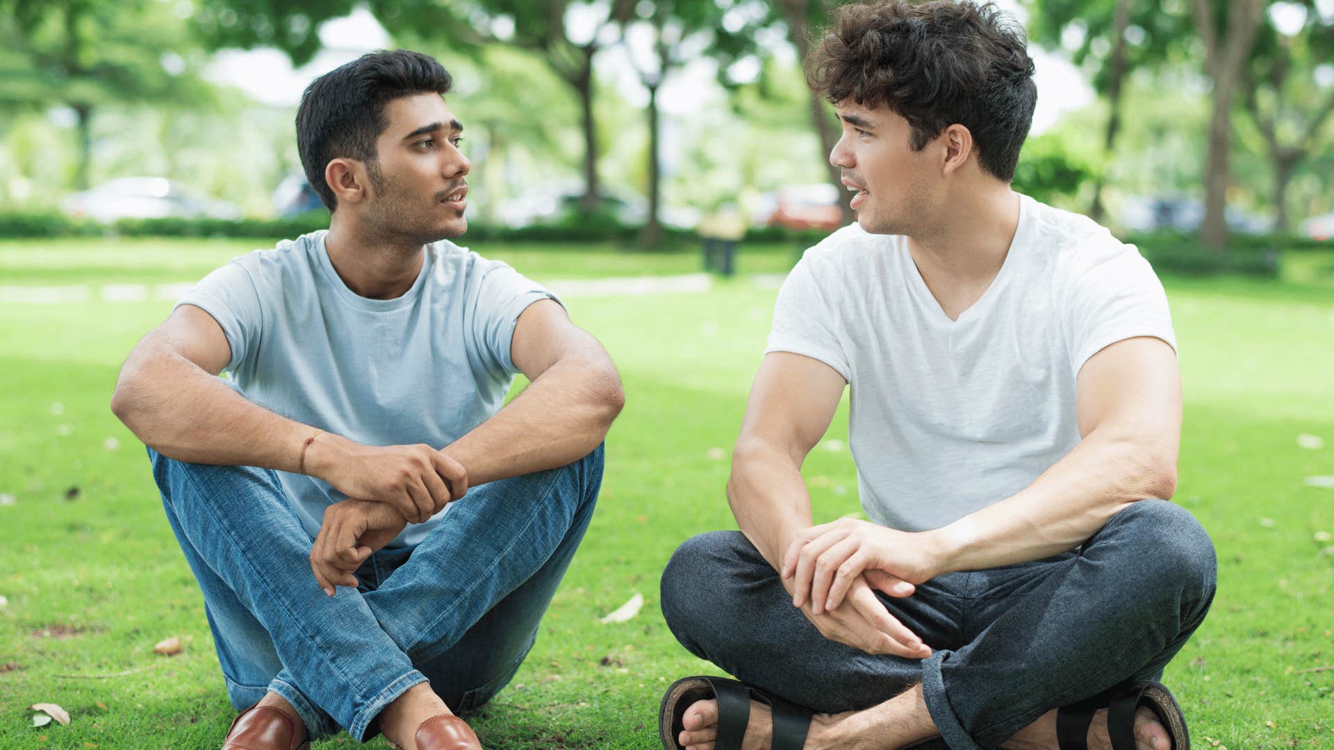 Couple sit in a park to find a good time to talk about their relationship