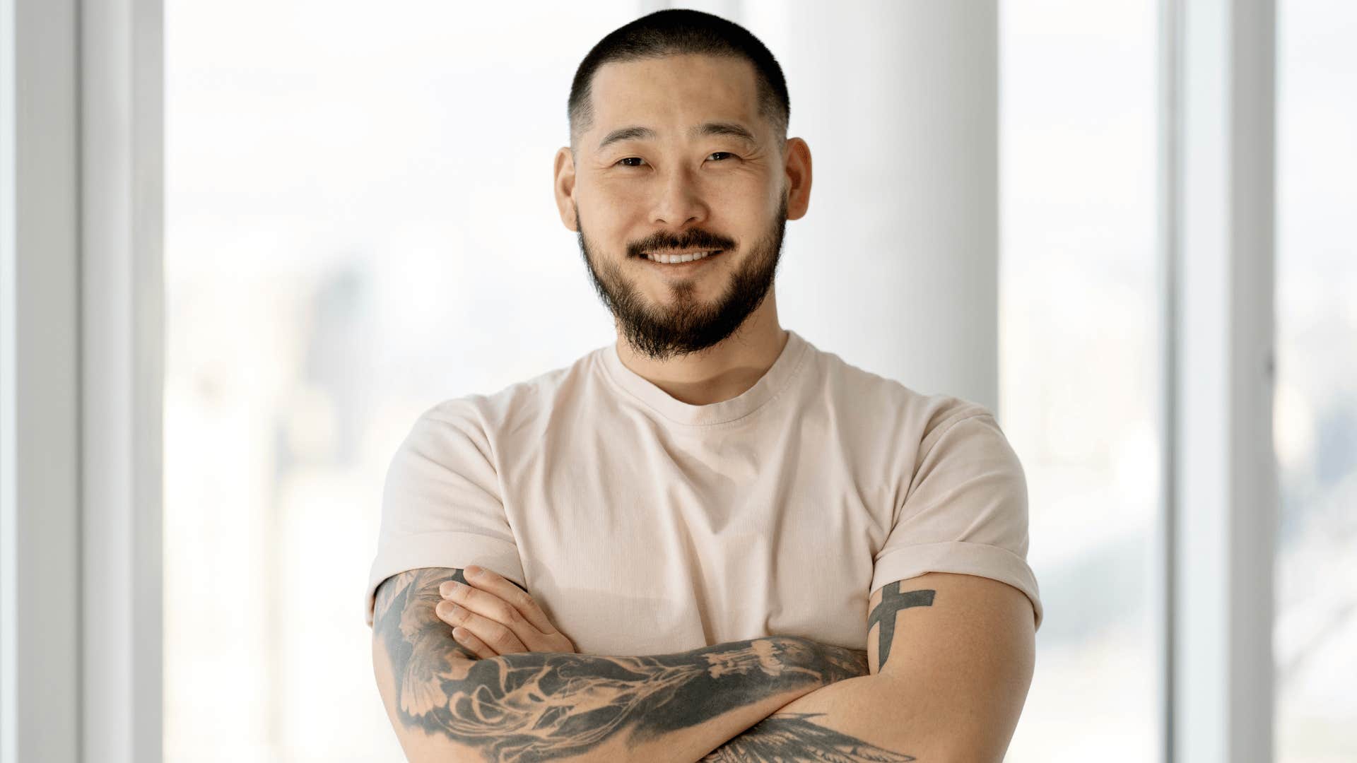 Smiling man crosses arms and is ready to answer questions