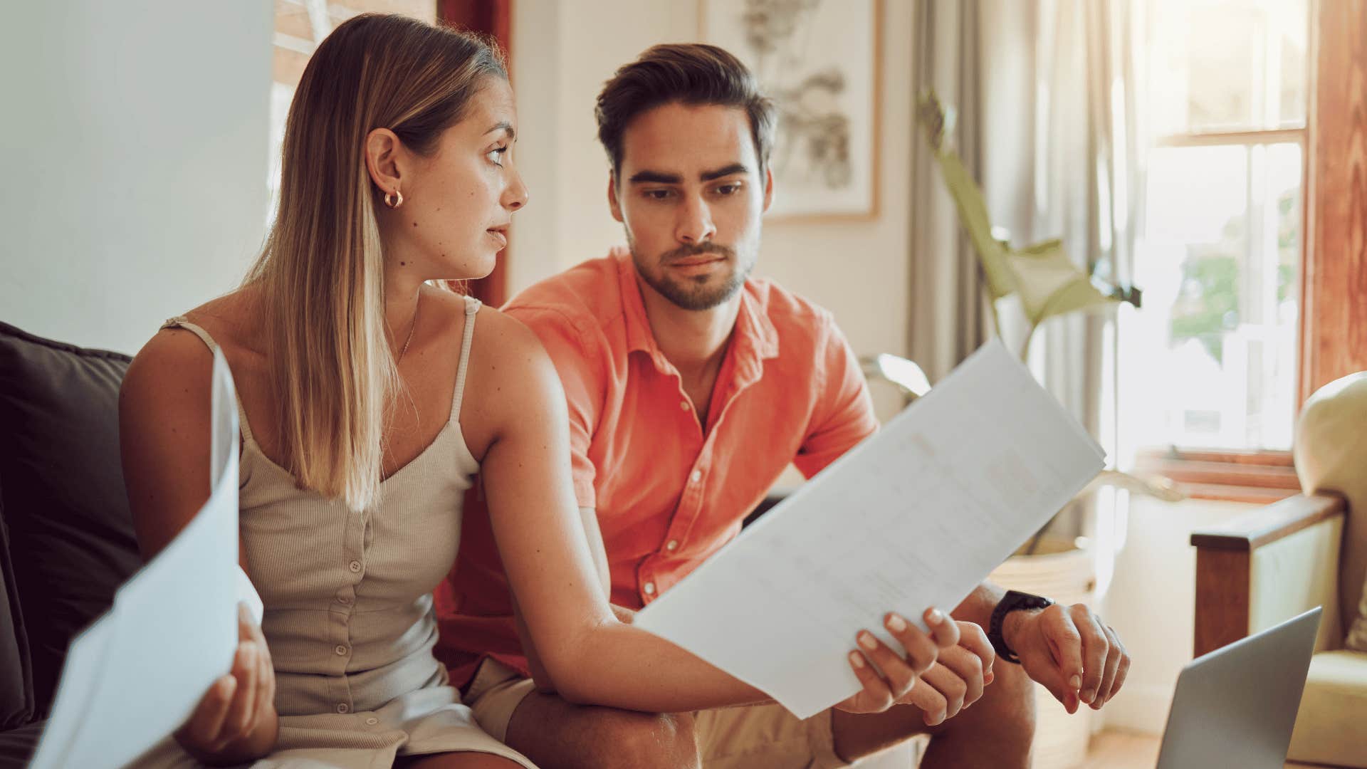 Worried couple looks at paparowrkj and wonders if they would still get married