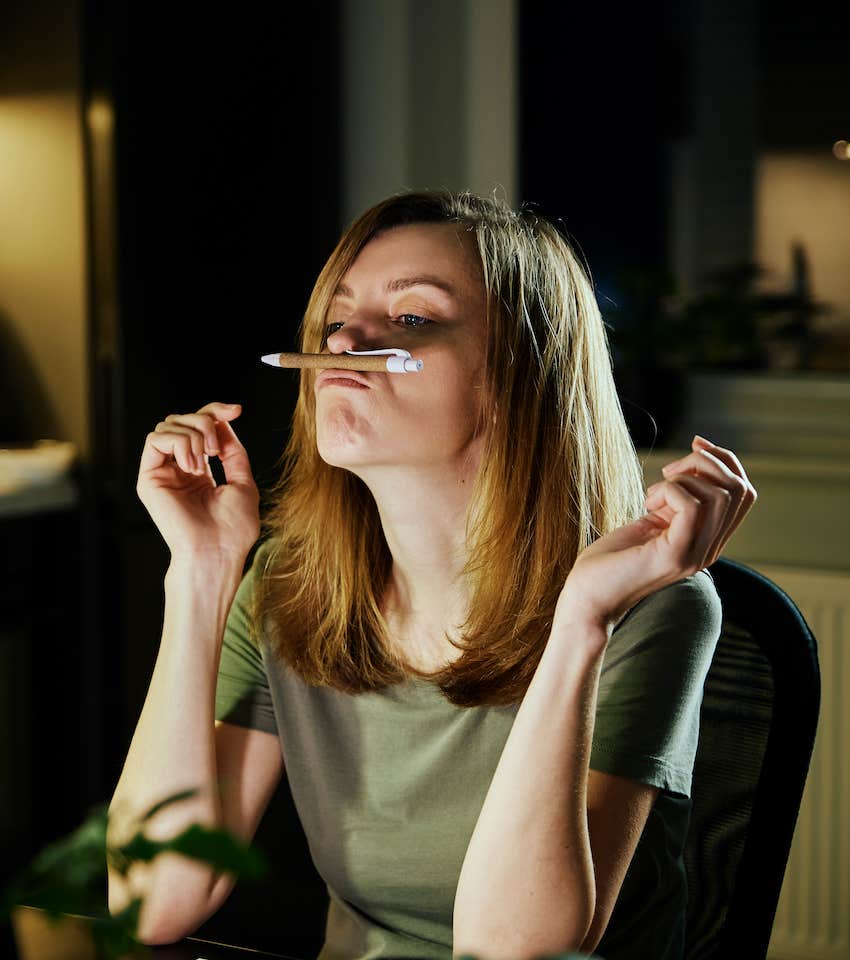 Lazy woman balances pencil on her lip