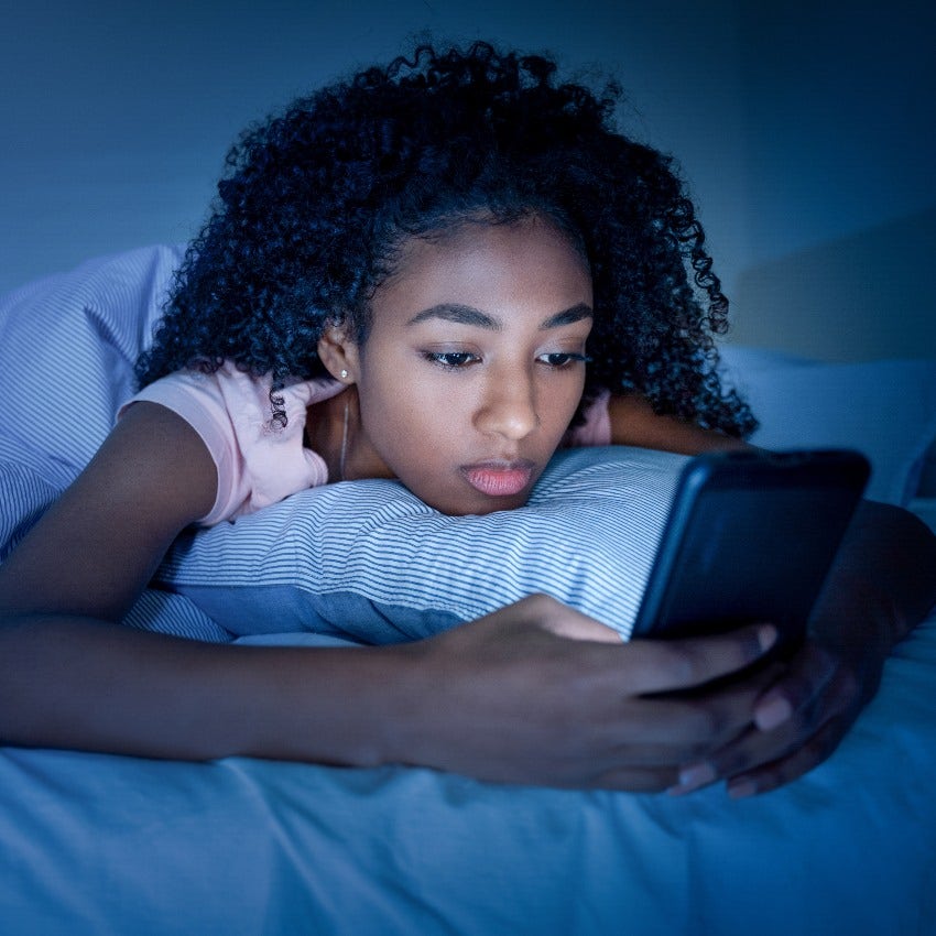 Woman on her phone before bed