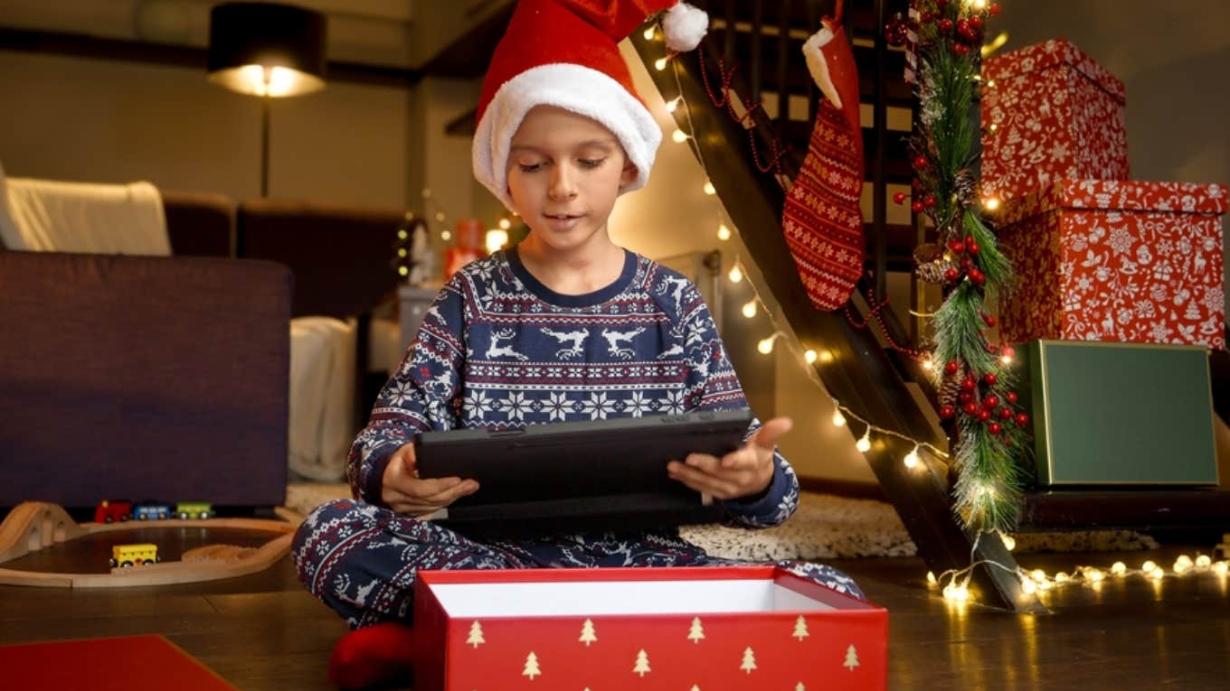 little boy opening video game gift 