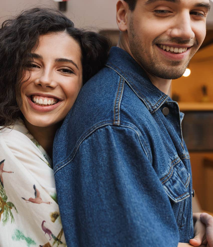 Woman who didn't settle hugs happy man