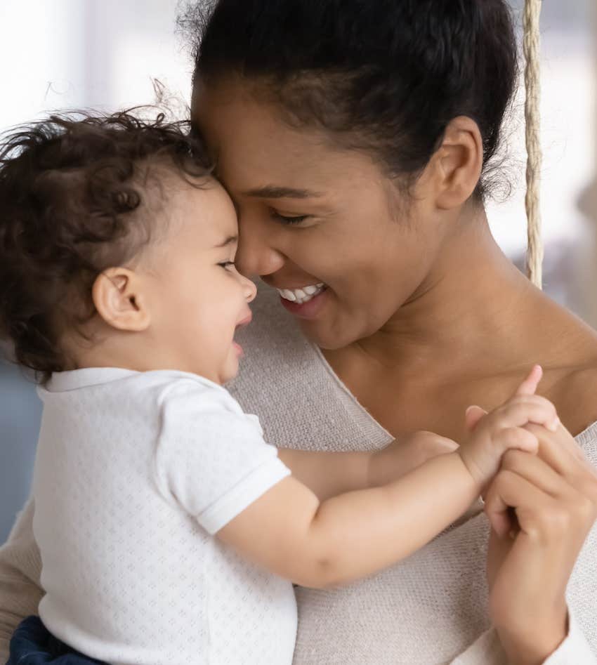 Smiling mother hold happy baby