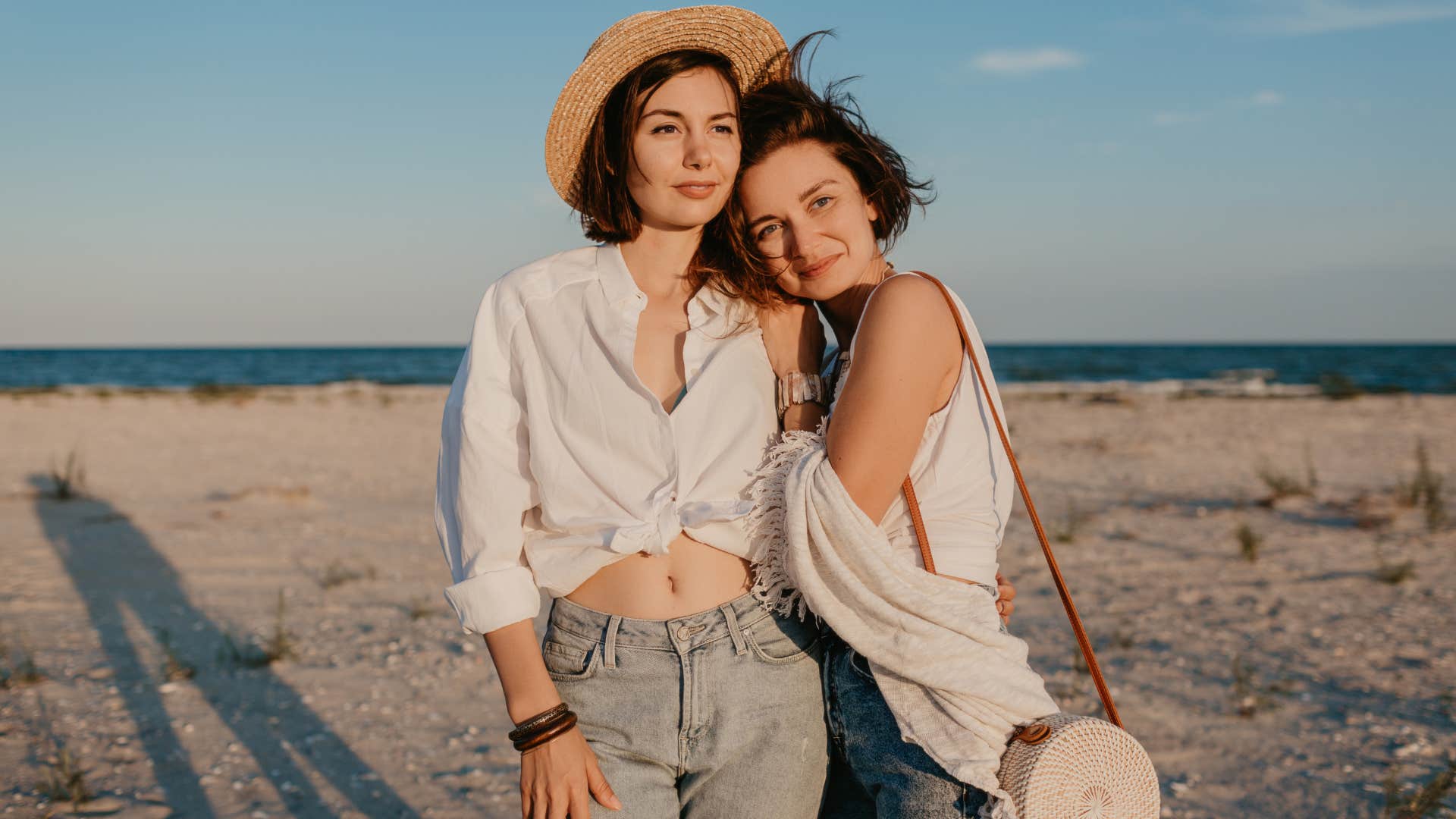 two women having fun on the sunset beach