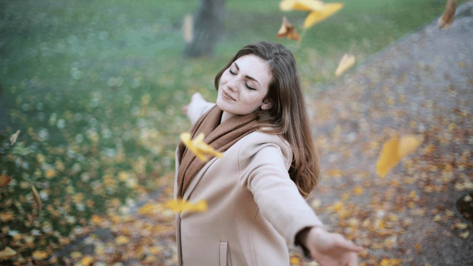 woman with her hands up and smiling