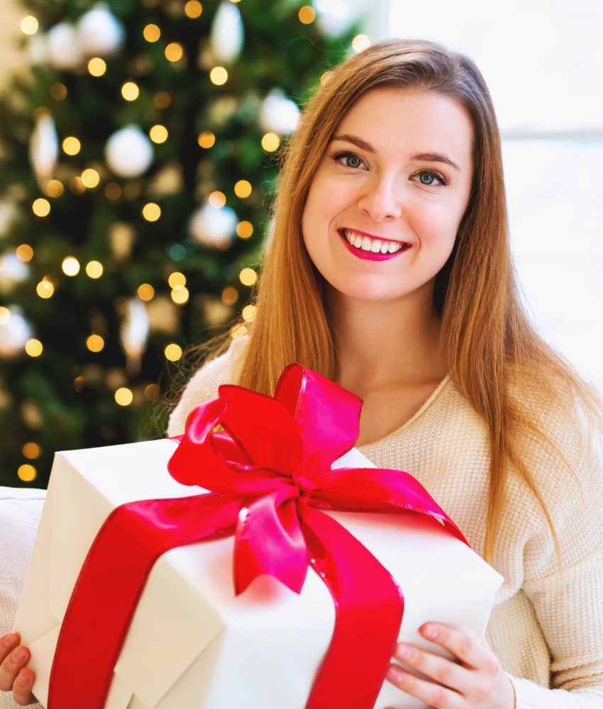 woman holding a large Christmas present