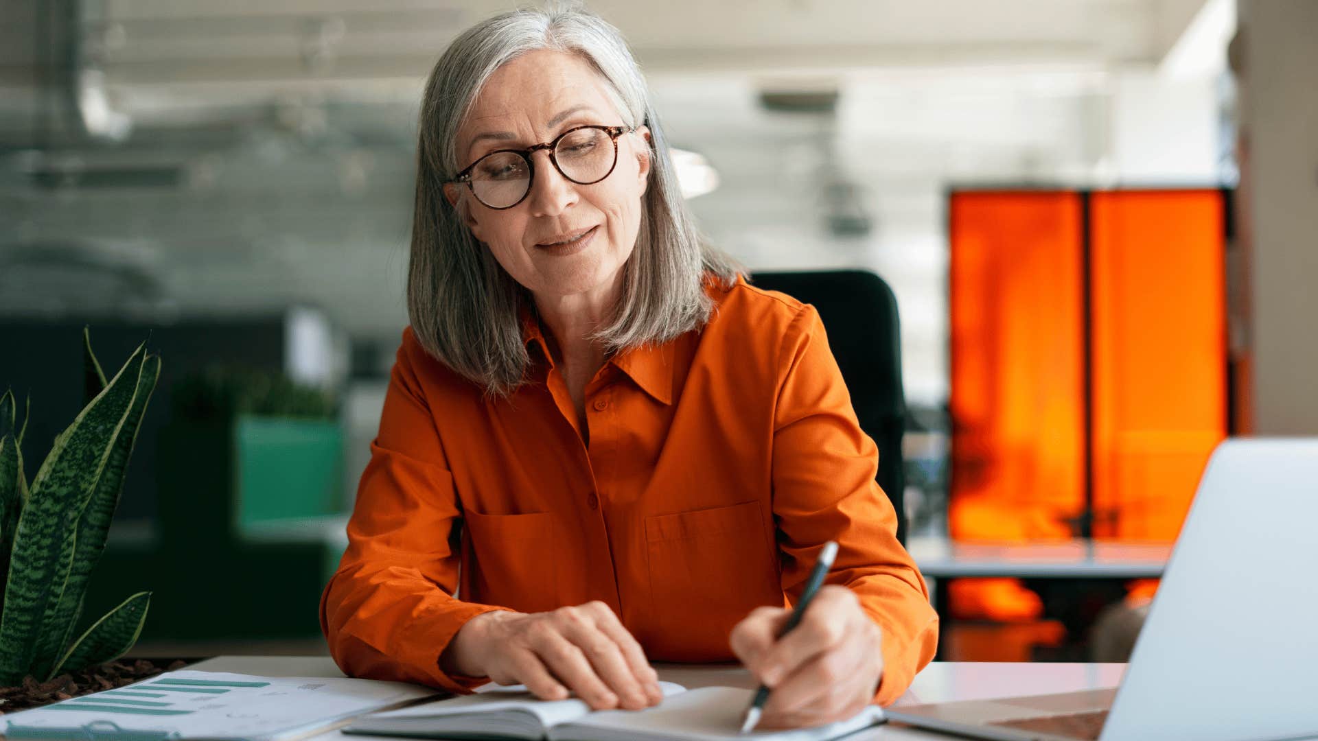 Older woman writes a note