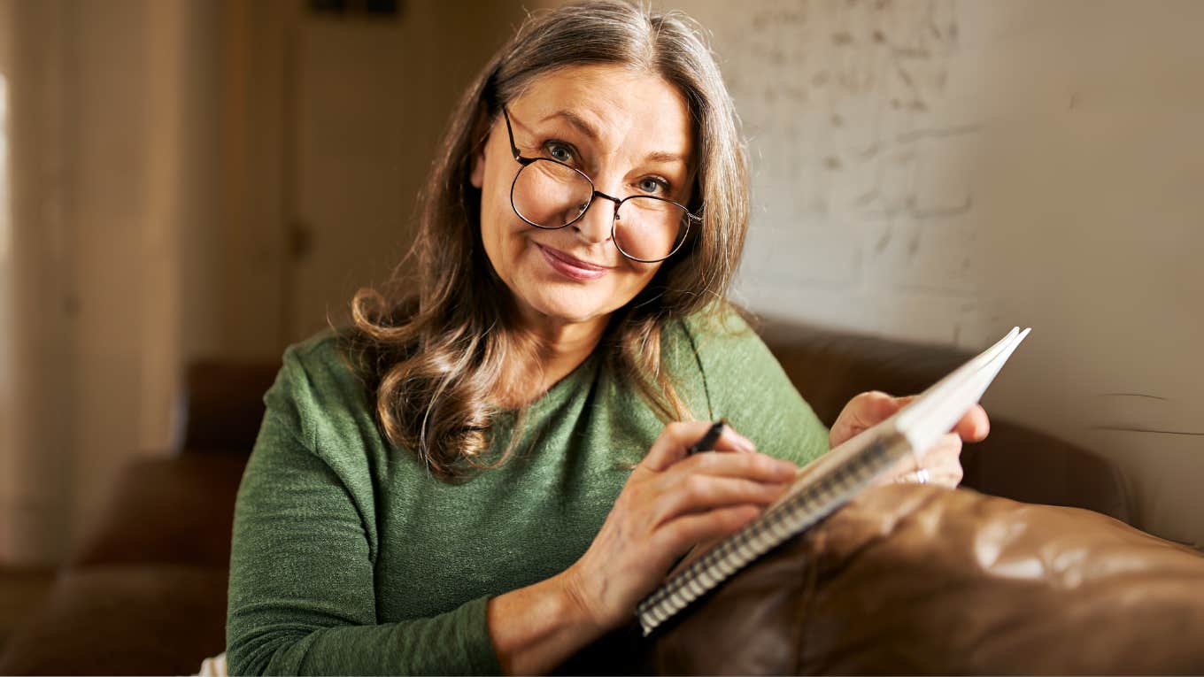 Boomer woman handwriting a letter of appreciation. 