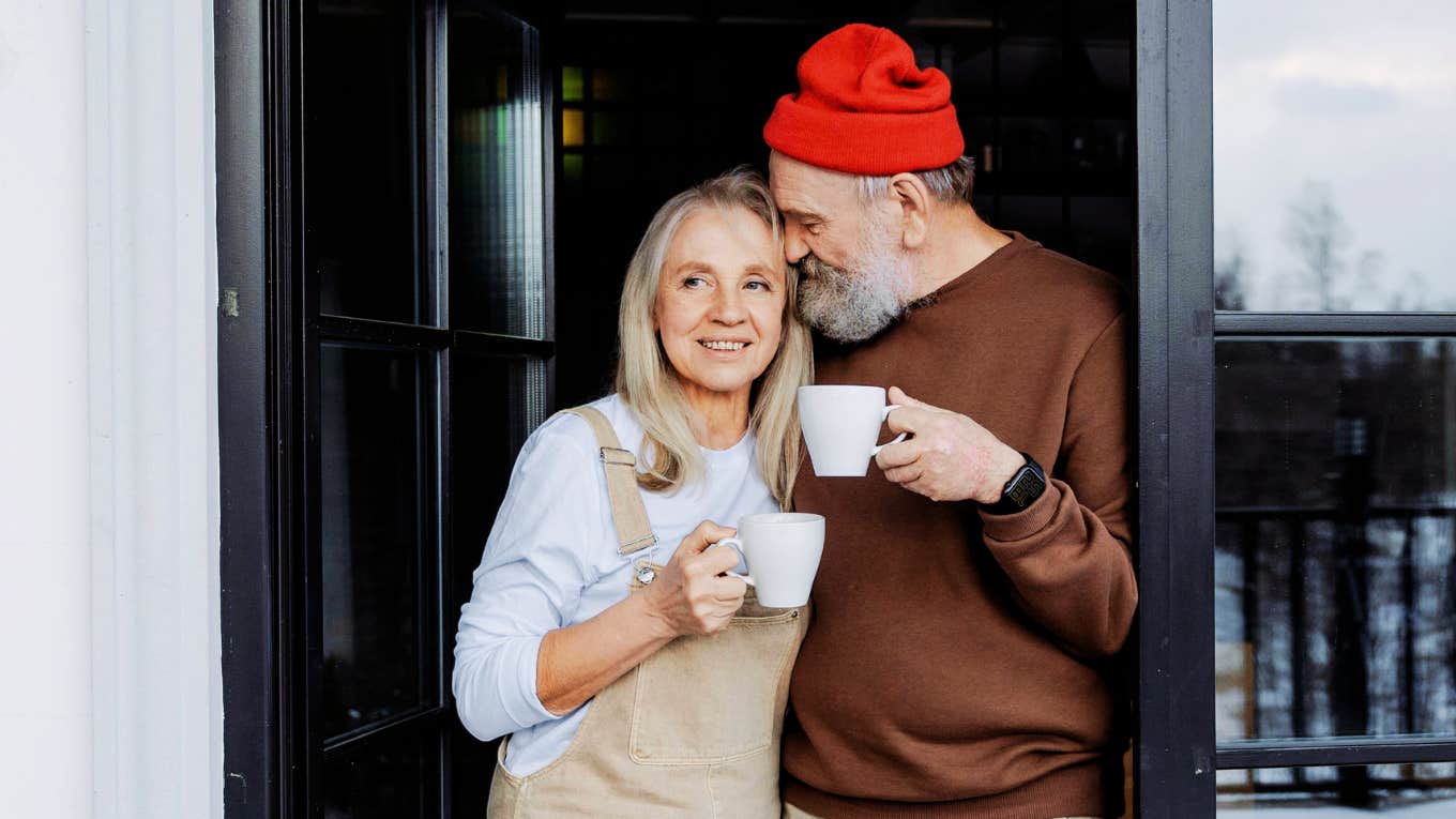 Boomer married couple, happily sharing a cup of tea together 