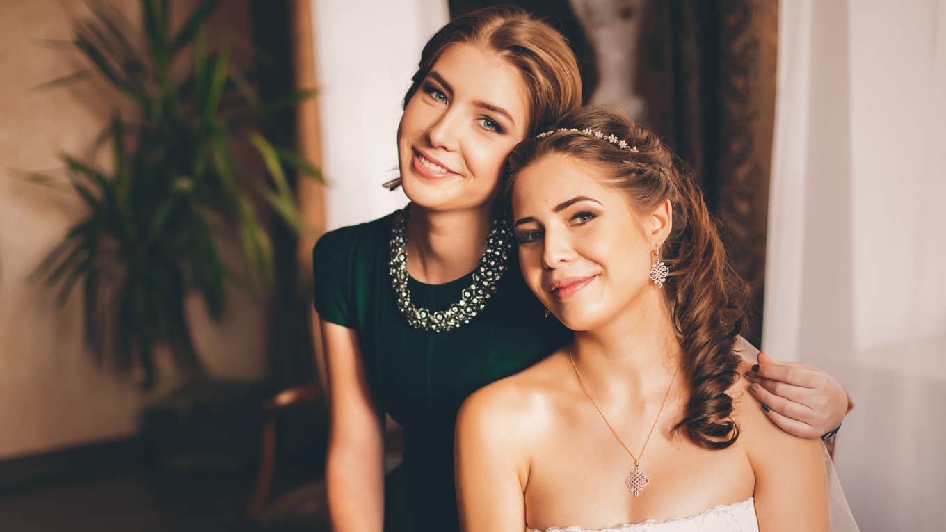 bride and sister posing in house