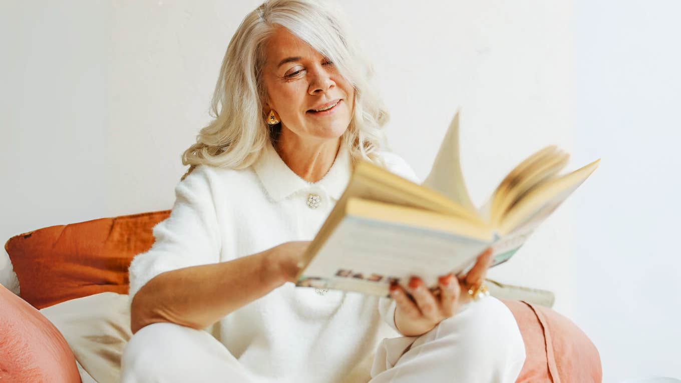 Woman enjoying time alone, reading a novel. 