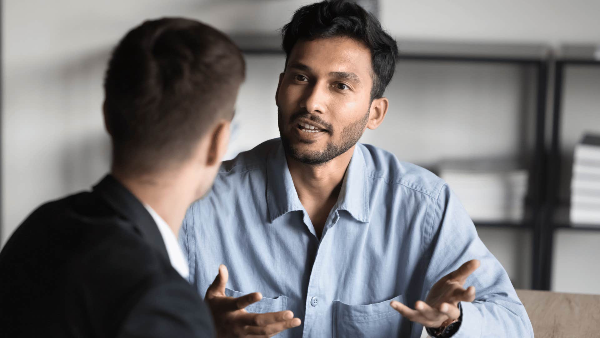 man explaining something to coworker