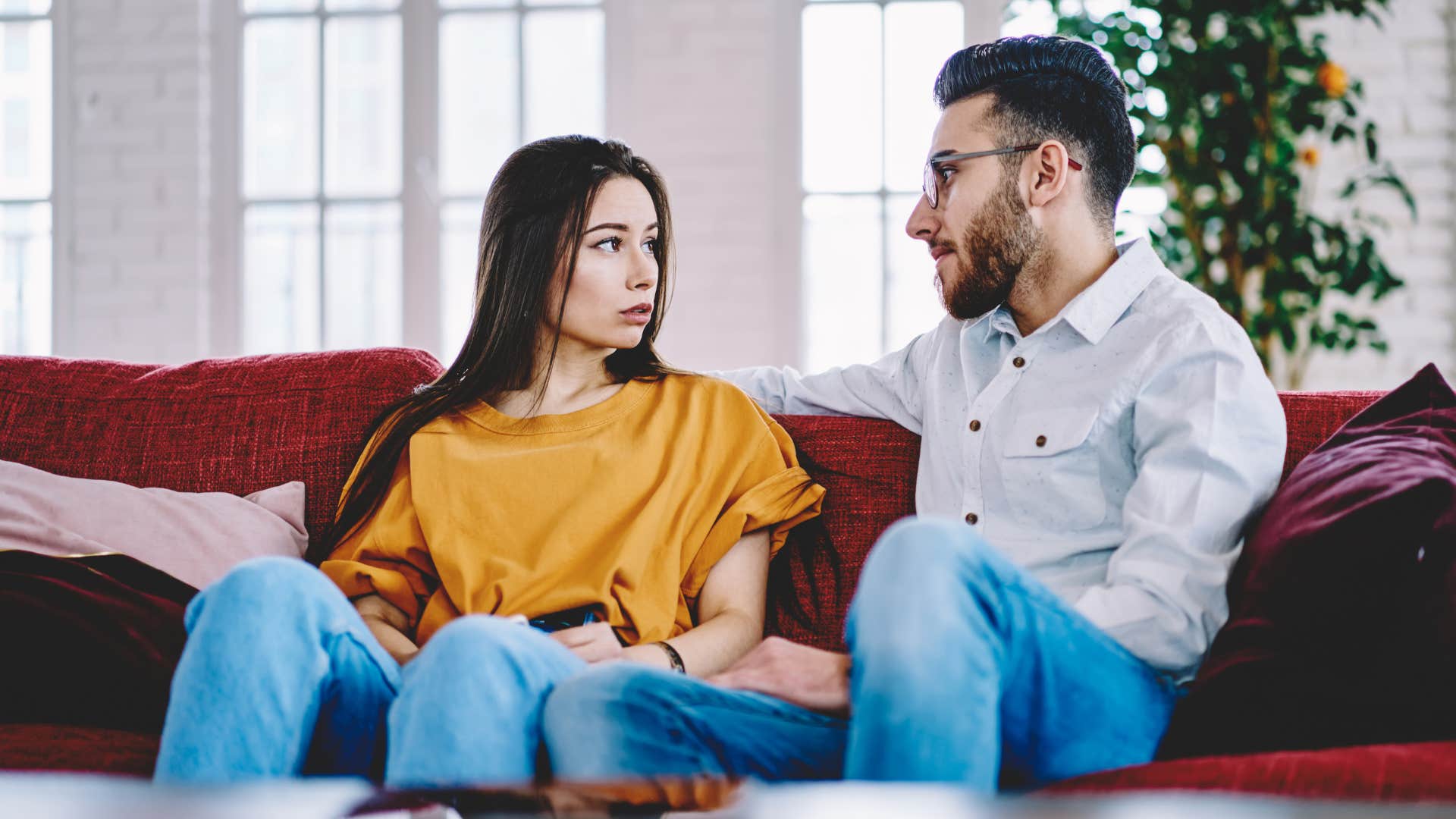 Couple sitting on the couch together.