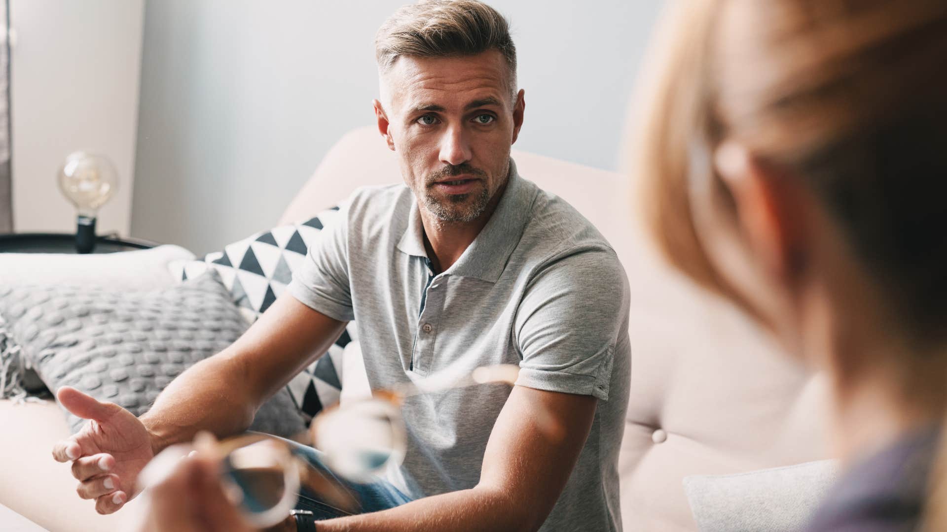 Man arguing with a woman at home.