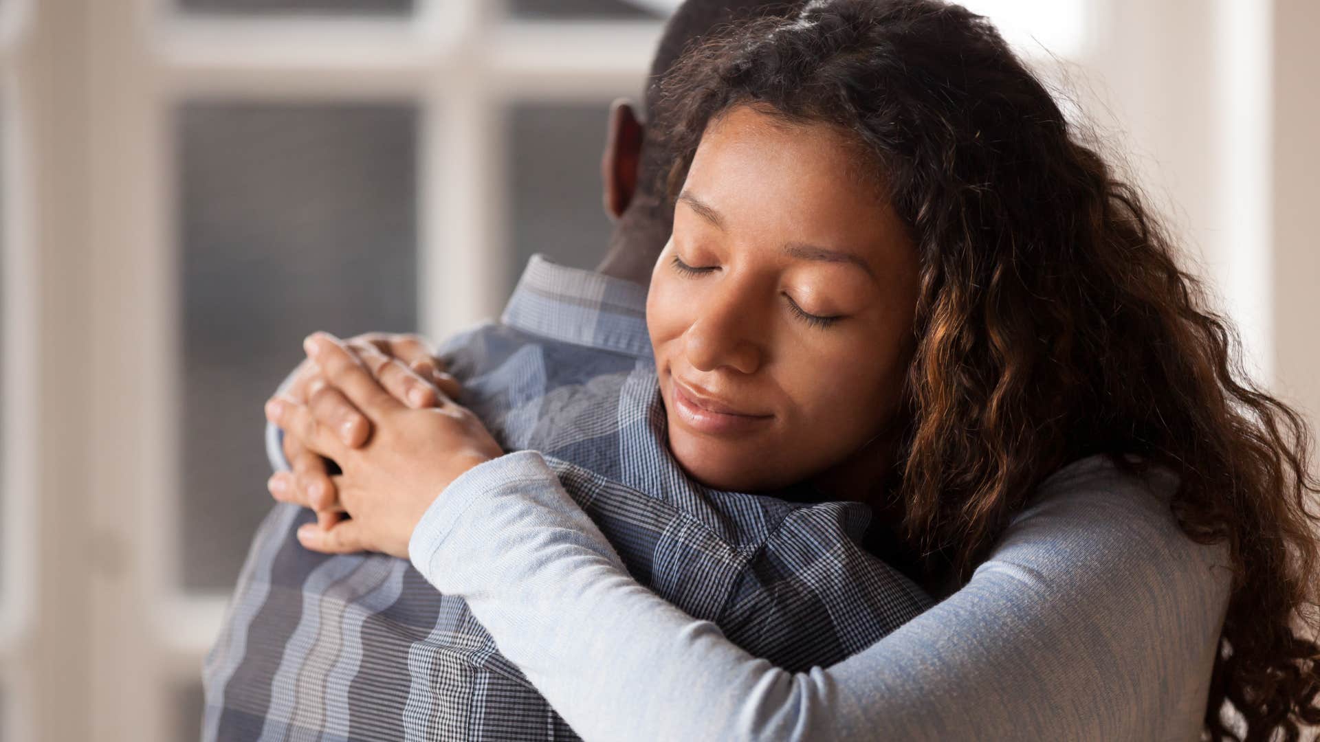 Woman hugging her partner and smiling