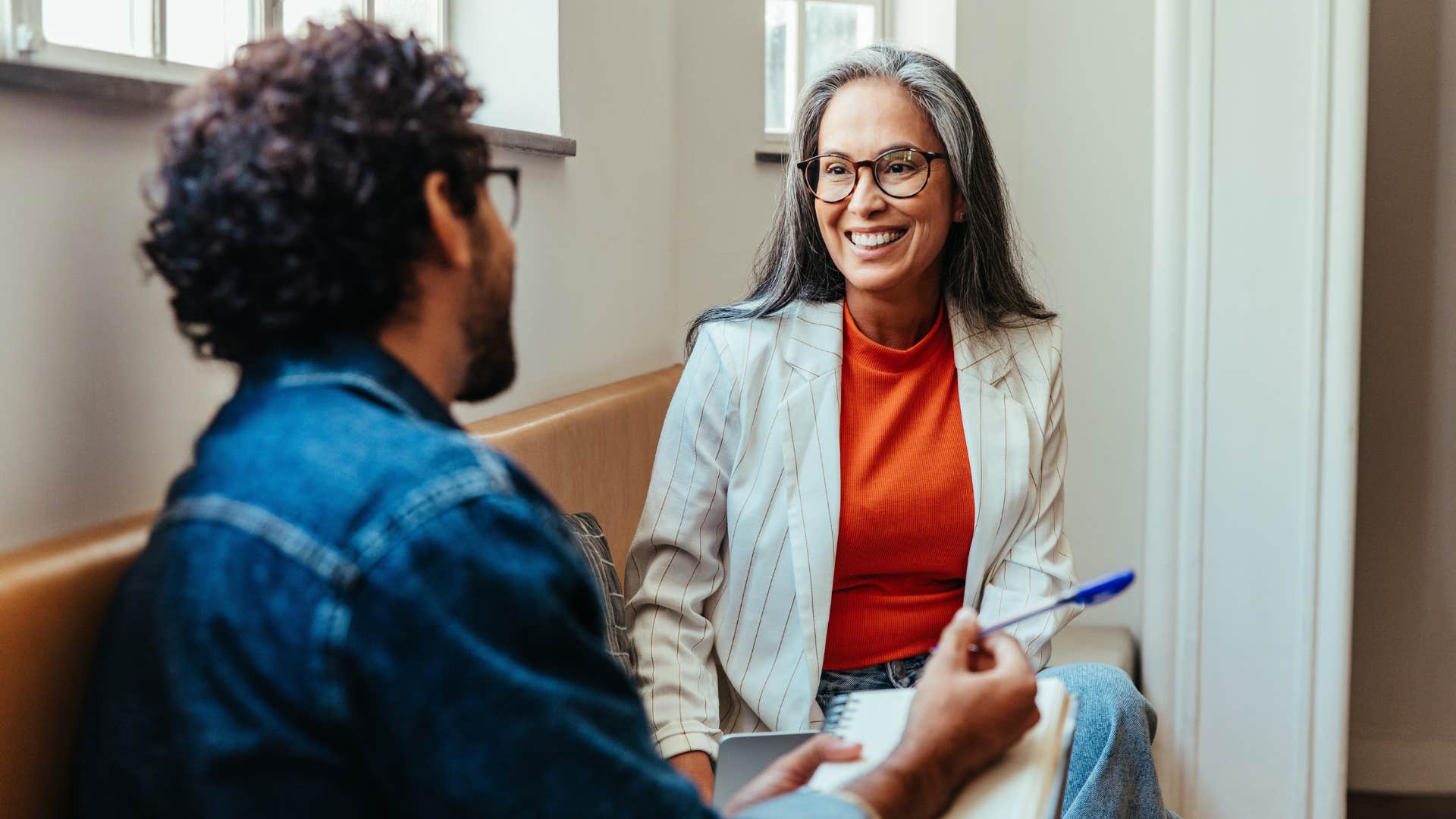 Woman smiling and talking to her co-worker