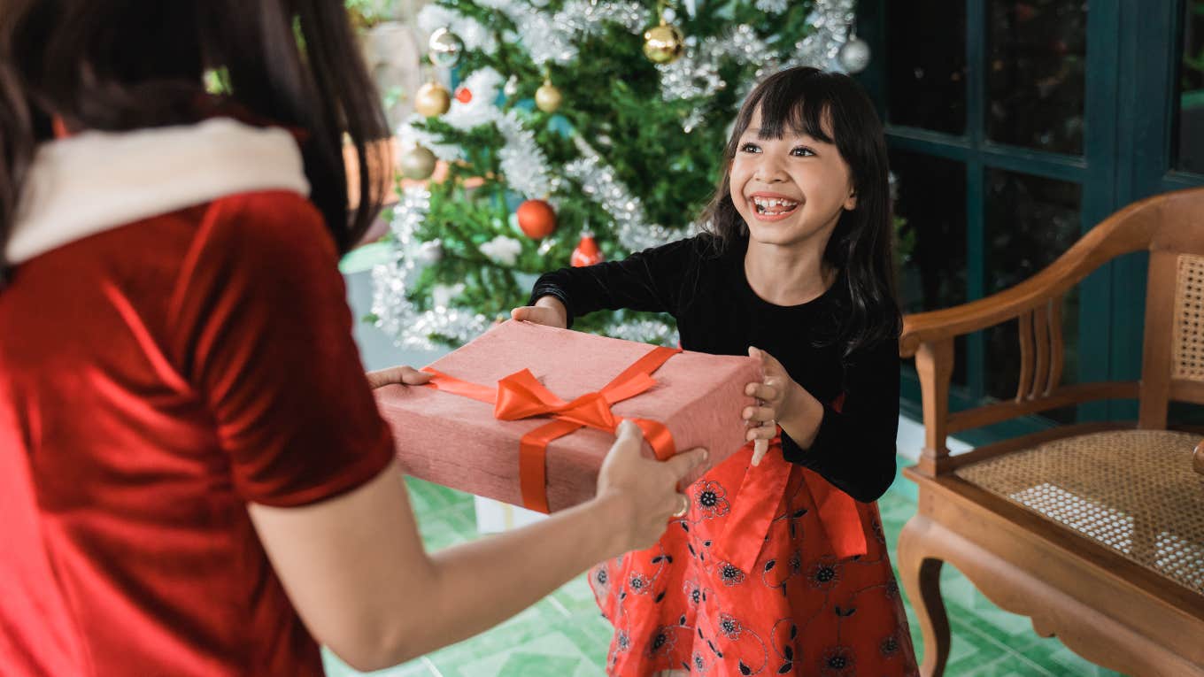 Little girl getting a gift during the holiday season