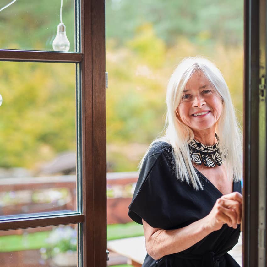 woman standing outside front door to do cinnamon abundance ritual