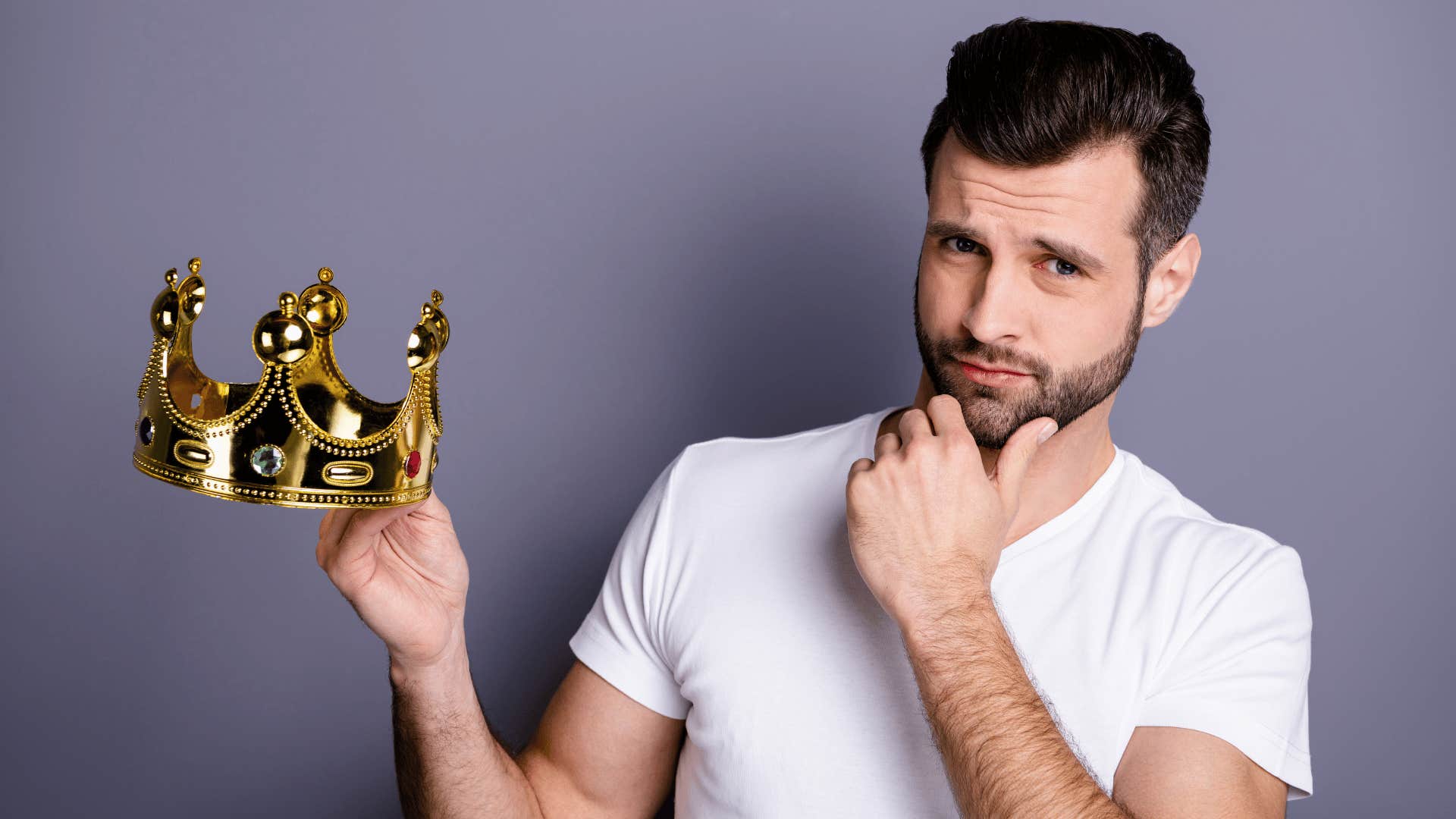 Egotistic man holds up crown because he comes first