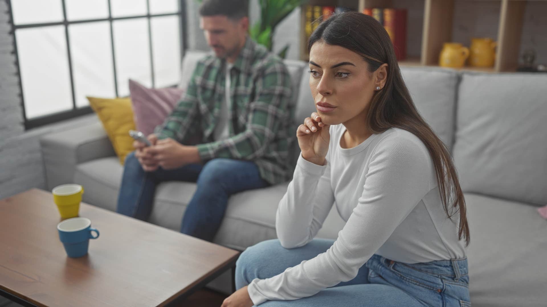 Woman turned away from her boyfriend on the couch.