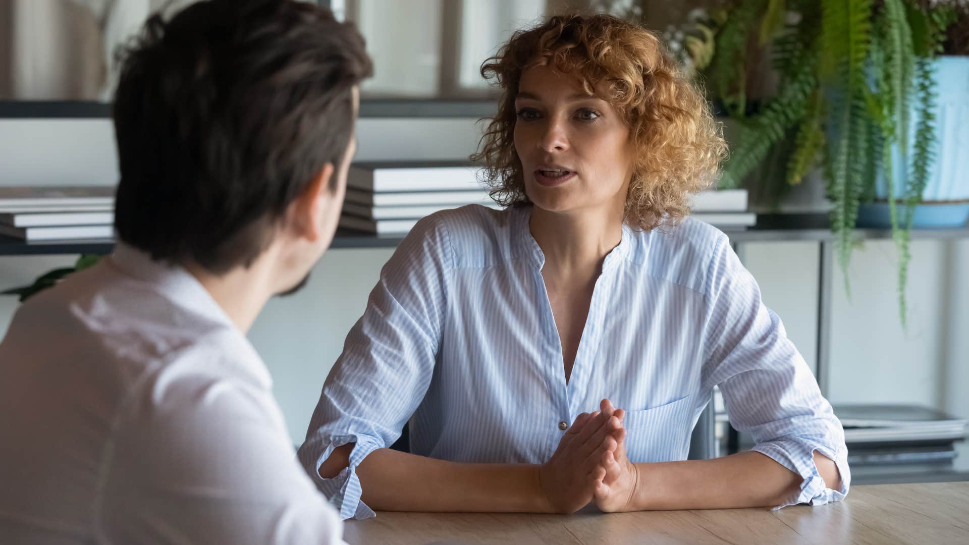 Woman looking seriously at her co-worker.