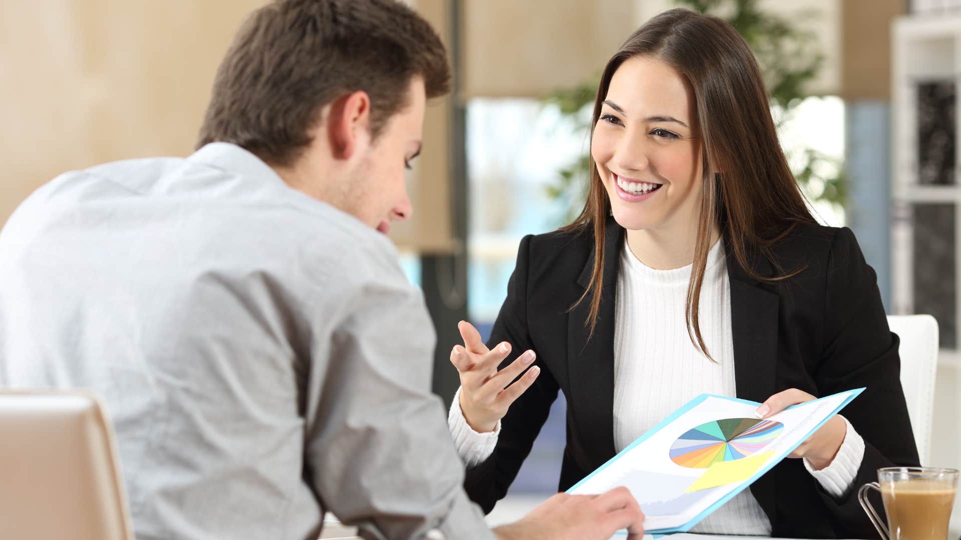 Professional woman showing her colleague a piece of paper.