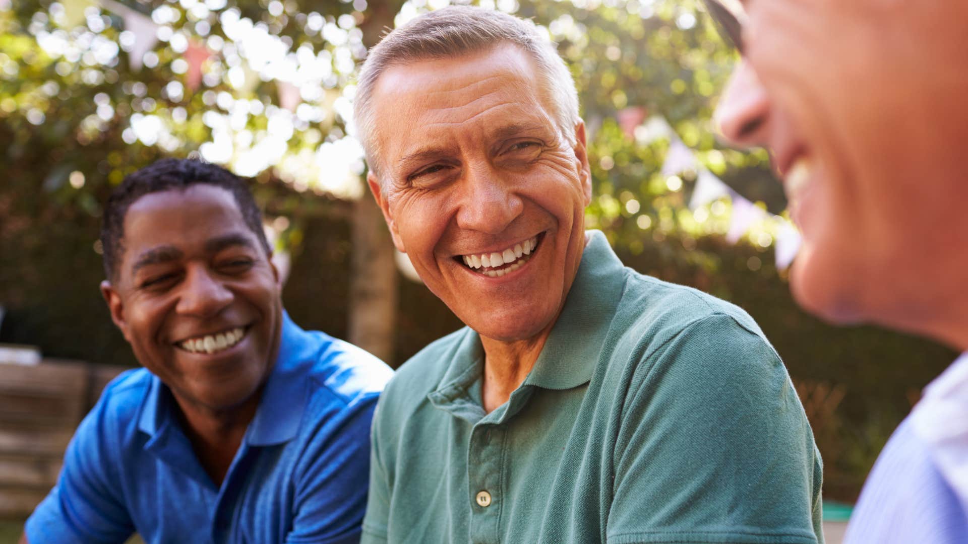 Older men smiling at each other.