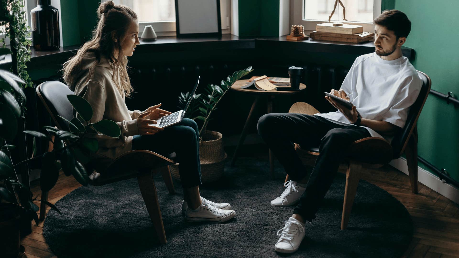 man and woman working while talking to each other